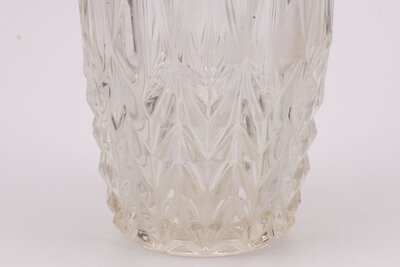 Imposant vase en verre avec son extrémité supérieur en forme de couronne et l'entièreté de l'objet est sculptée avec des formes triangulaires.