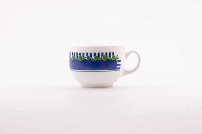 Tasse à café vintage en porcelaine blanche avec des motifs bleus et verts de chez Arcopal