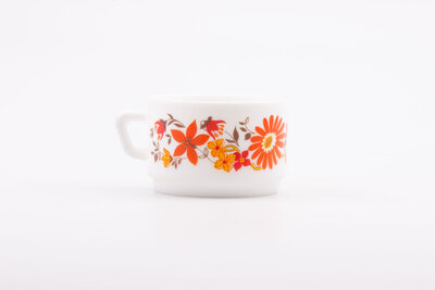 Tasse à café vintage en opaline blanche et des motifs floraux rouges et oranges de la collection Flore d'Arcopal 