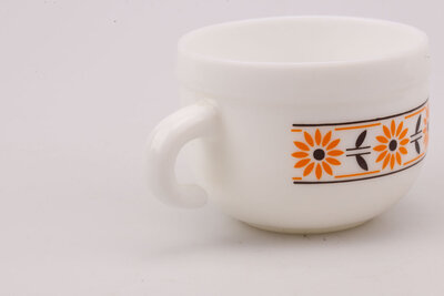 Bol vintage en opaline blanche avec un motif orange et noir de chez Cerve