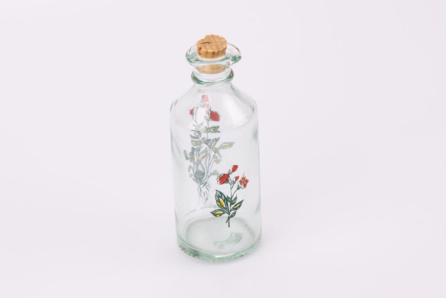 Flacon vintage en verre à bec verseur avec une fleur de Sibérie comme motif